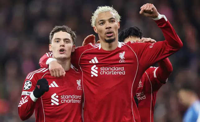 Liverpool's Florian Wirtz, left, celebrates with Liverpool's Hugo Ekitike after scoring his side's second goal during the Champions League soccer match between Liverpool and Qarabag in Liverpool, Wednesday, Jan. 28, 2026. (AP Photo/Darren Staples)
