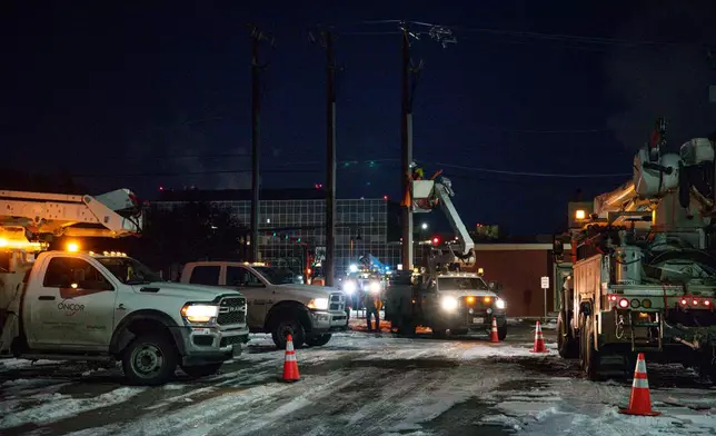 FILE - An Oncor Electric Delivery lineman crew works on repairing a utility pole that was damaged by a winter storm on Feb. 18, 2021, in Odessa, Texas. (Eli Hartman/Odessa American via AP, File)