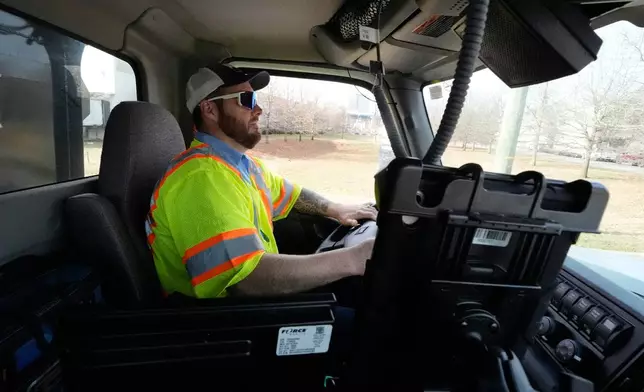 Austin Felts of the Nashville Department of Transportation drives a truck deploying salt brine on roadways Thursday, Jan. 22, 2026, in Nashville, Tenn. ahead of a winter storm expected to hit the state over the weekend. (AP Photo/George Walker IV)