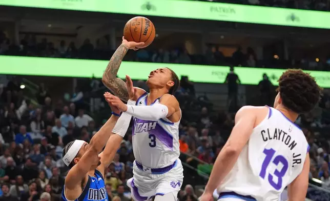 Utah Jazz guard Keyonte George (3) shoots against Dallas Mavericks guard Ryan Nembhard (9) during the first half of an NBA basketball game in Dallas, Thursday, Jan. 15, 2026. (AP Photo/LM Otero)
