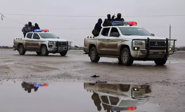 Syrian government forces drive inside the al-Aqtan prison after taking control of it from the Kurdish-led Syrian Democratic Forces, SDF, in Raqqa, northeastern Syria, Friday, Jan. 23, 2026. (AP Photo/Ghaith Alsayed)