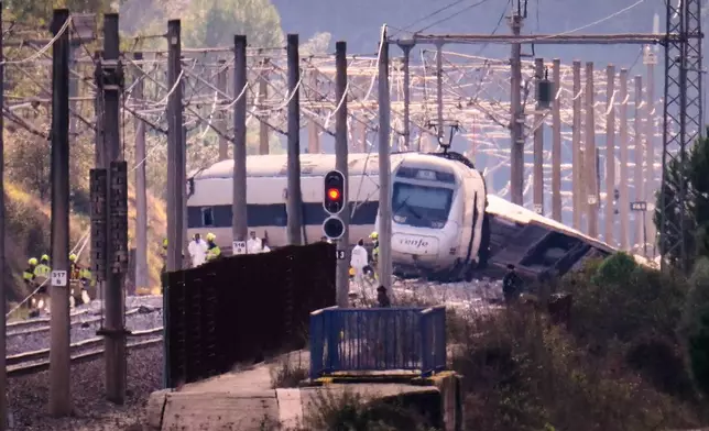 Emergency crews work at the site of a train collision in Adamuz, southern Spain, Monday, Jan. 19, 2026. (AP Photo/Manu Fernandez)