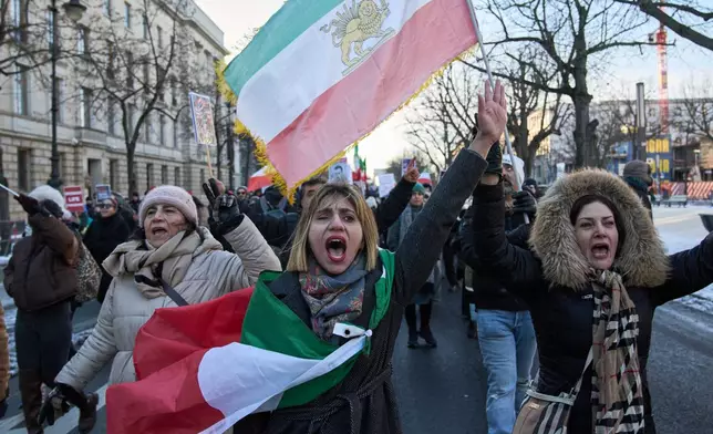 Protesters participate in a demonstration in front of the Brandenburg Gate in Berlin, Germany, in support of the nationwide mass protests in Iran against the government, Sunday, Jan. 11, 2026. (AP Photo/Ebrahim Noroozi)