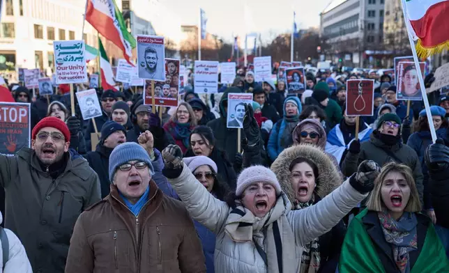 Protesters participate in a demonstration in front of the Brandenburg Gate in Berlin, Germany, in support of the nationwide mass protests in Iran against the government, Sunday, Jan. 11, 2026. (AP Photo/Ebrahim Noroozi)