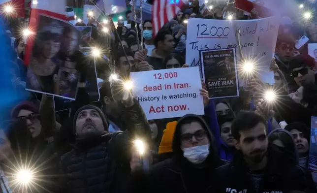 Iranian protesters participate in a demonstration in front of the US Consulate in Milan, Italy, Tuesday, Jan. 13, 2026, in support of the nationwide mass protests in Iran against the government. (AP Photo/Luca Bruno)