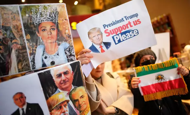 People hold up photos of Reza Pahlavi, the son of Iran's toppled Shah Mohammad Reza Pahlavi, during a small demonstration, in Istanbul, Sunday, Jan. 11, 2026, in support of the nationwide mass protests in Iran against the government. (AP Photo/Emrah Gurel)