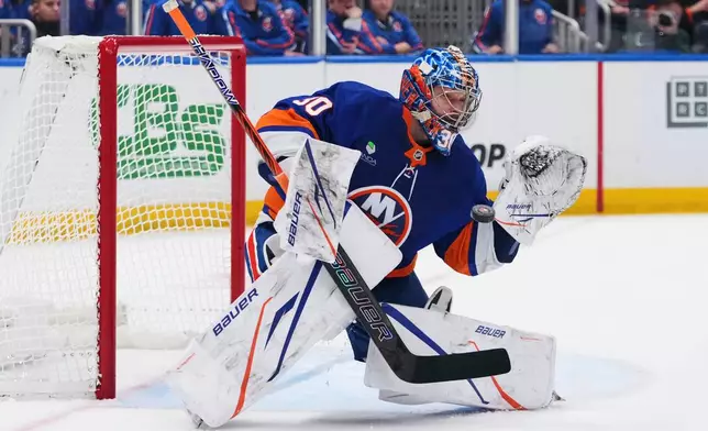 New York Islanders goaltender Ilya Sorokin (30) stops a shot during the second period of an NHL hockey game against the New Jersey Devils Tuesday, Jan. 6, 2026, in Elmont, N.Y. (AP Photo/Frank Franklin II)