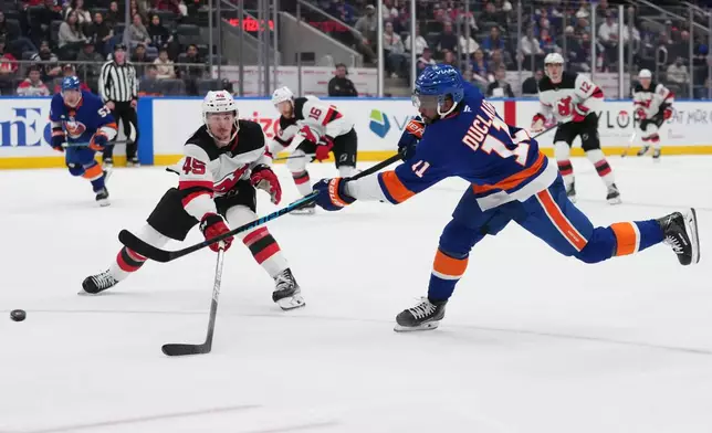 New York Islanders' Anthony Duclair (11) shoots the puck past New Jersey Devils' Colton White (45) for a goal during the first period of an NHL hockey game Tuesday, Jan. 6, 2026, in Elmont, N.Y. (AP Photo/Frank Franklin II)