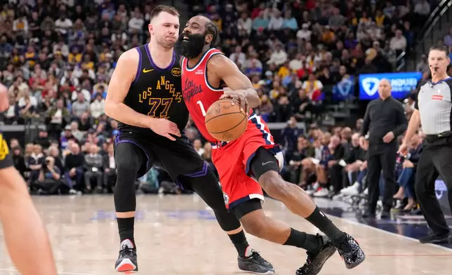 Los Angeles Clippers guard James Harden, right, drives past Los Angeles Lakers guard Luka Doncic during the second half of an NBA basketball game Thursday, Jan. 22, 2026, in Inglewood, Calif. (AP Photo/Mark J. Terrill)