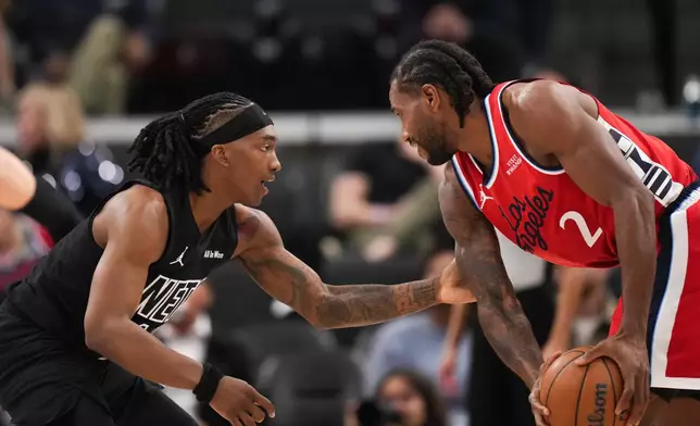 Brooklyn Nets guard/forward Terance Mann (14) pressures Los Angeles Clippers forward Kawhi Leonard (2) during the first half of an NBA basketball game Sunday, Jan. 25, 2026, in Inglewood, Calif. (AP Photo/Jae C. Hong)