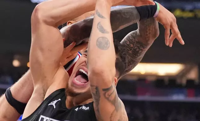 Brooklyn Nets forward Michael Porter Jr. (17) is fouled by Los Angeles Clippers forward/center John Collins during the first half of an NBA basketball game Sunday, Jan. 25, 2026, in Inglewood, Calif. (AP Photo/Jae C. Hong)