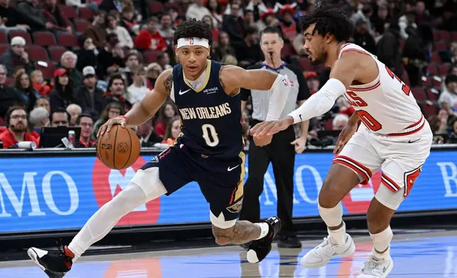 New Orleans Pelicans' Jeremiah Fears (0) drives against Chicago Bulls' Tre Jones during the first half of an NBA basketball game, Wednesday, Dec. 31, 2025, in Chicago. (AP Photo/Paul Beaty)