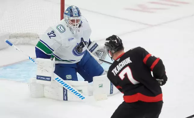 Ottawa Senators left wing Brady Tkachuk (7) shoots on Vancouver Canucks goaltender Kevin Lankinen (32) during first period NHL action in Ottawa, Tuesday, Jan. 13, 2026. (Adrian Wyld/The Canadian Press via AP)