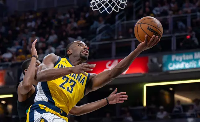 Indiana Pacers guard Aaron Nesmith (23) shoots during the first half of an NBA basketball game against the San Antonio Spurs in Indianapolis, Friday, Jan. 2, 2026. (AP Photo/Doug McSchooler)