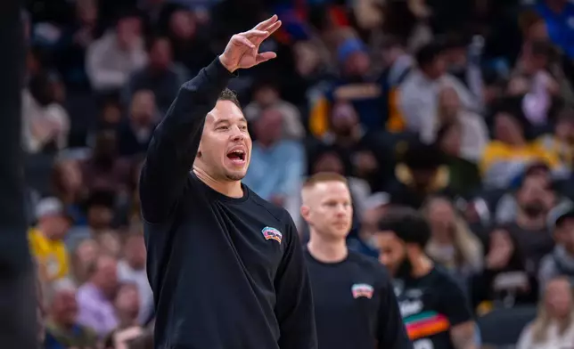 San Antonio Spurs head coach Mitch Johnson gestures during the first half of an NBA basketball game against the Indiana Pacers in Indianapolis, Friday, Jan. 2, 2026. (AP Photo/Doug McSchooler)