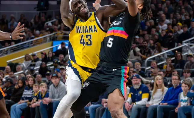 Indiana Pacers forward Pascal Siakam (43) makes contact with San Antonio Spurs guard Stephon Castle (5) as he drives to the basket during the first half of an NBA basketball game in Indianapolis, Friday, Jan. 2, 2026. (AP Photo/Doug McSchooler)