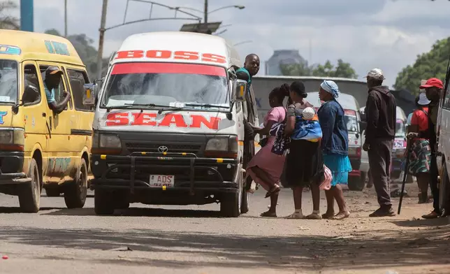 People board a minibus in Harare, Zimbabwe, Tuesday, Dec. 16, 2025. (AP Photo/Aaron Ufumeli)