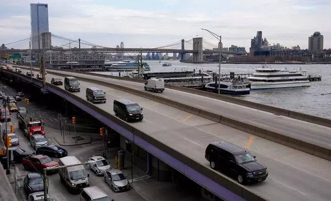 A motorcade makes its way down the FDR Drive after leaving Manhattan Federal Court where Venezuelan President Nicolas Maduro was arraigned with his wife Cilia Flores, Monday, Jan. 5, 2026, in New York. (AP Photo/Seth Wenig)