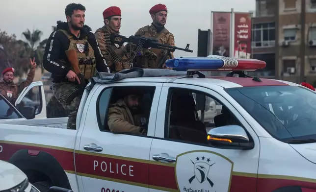 Syrian government soldiers ride a vehicle during clashes with Kurdish fighters in a contested area of the northern city of Aleppo, Syria, Wednesday, Jan. 7, 2026. (AP Photo/Ghaith Alsayed)