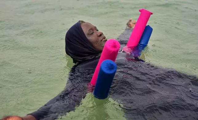 FILE - A participant floats during an aquatic therapy session in the ocean in Dakar, Senegal, Saturday, Dec. 6, 2025. (AP Photo/Misper Apawu, File)