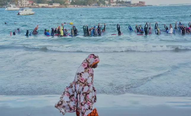 FILE - People take part in a group aquatic therapy session in the ocean in Dakar, Senegal, Saturday, Dec. 13, 2025. (AP Photo/Misper Apawu, File)