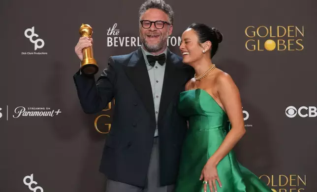 Seth Rogen, left, and Chase Sui Wonders pose in the press room with the award for best television series – musical or comedy for "The Studio" during the 83rd Golden Globes on Sunday, Jan. 11, 2026, at the Beverly Hilton in Beverly Hills, Calif. (AP Photo/Chris Pizzello)