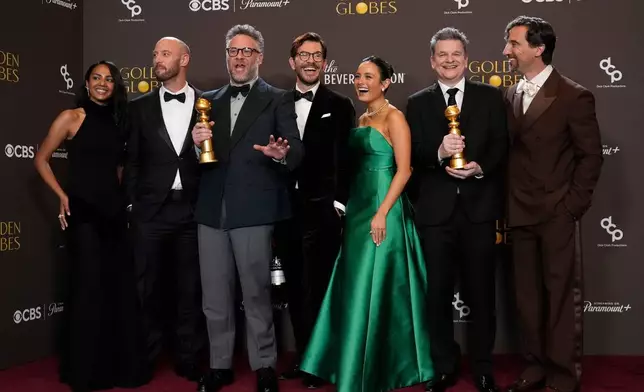 Frida Perez, from left, Evan Goldberg, Seth Rogen, Peter Huyck, Chase Sui Wonders, Alex Gregory, and James Weaver pose in the press room with the award for best television series – musical or comedy for "The Studio" during the 83rd Golden Globes on Sunday, Jan. 11, 2026, at the Beverly Hilton in Beverly Hills, Calif. (AP Photo/Chris Pizzello)