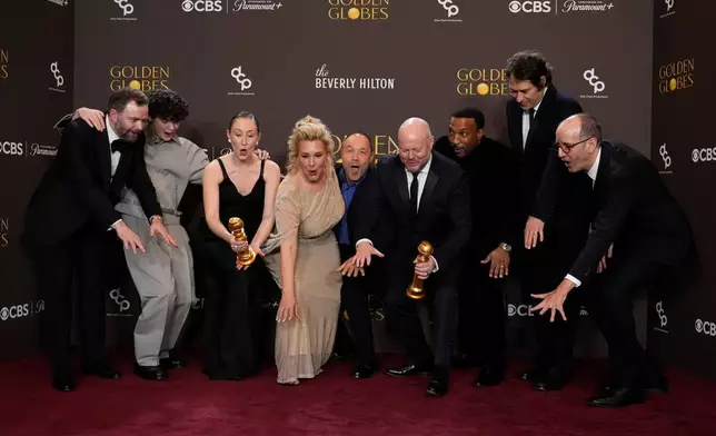 Philip Barantini, from left, Owen Cooper, Erin Doherty, Hannah Walters, Stephen Graham, Andy Cooper, Ashley Walters, Jeremy Kleiner, and Jack Thorne pose in the press room with the award for best television limited series, anthology series or motion picture made for television for "Adolescence" during the 83rd Golden Globes on Sunday, Jan. 11, 2026, at the Beverly Hilton in Beverly Hills, Calif. (AP Photo/Chris Pizzello)