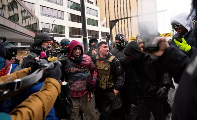 Jake Lang, center in the vest, who organized the March Against Minnesota Fraud, clashes with pro-immigration counterprotesters near Minneapolis City Hall, Saturday, Jan. 17, 2026, in Minneapolis. (AP Photo/Yuki Iwamura)