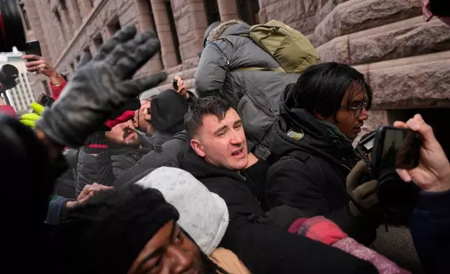 Jake Lang, center, who organized the protest March Against Minnesota Fraud, clashes with pro-immigration counterprotesters near Minneapolis City Hall, Saturday, Jan. 17, 2026, in Minneapolis. (AP Photo/Yuki Iwamura)