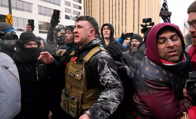 Jake Lang, center, who organized the March Against Minnesota Fraud, clashes with pro-immigration counterprotesters near Minneapolis City Hall, Saturday, Jan. 17, 2026, in Minneapolis. (AP Photo/Yuki Iwamura)
