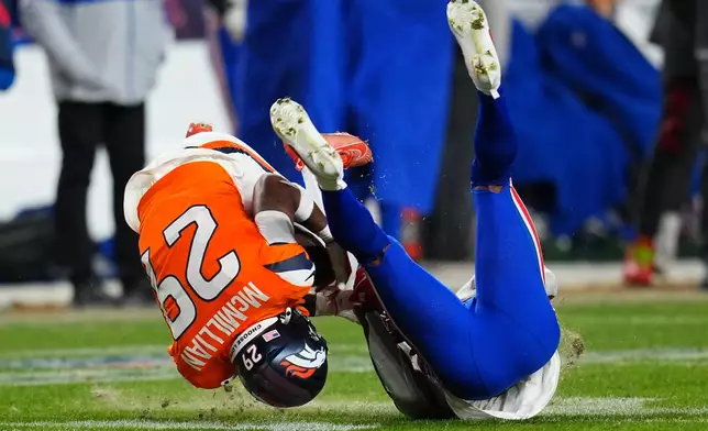Denver Broncos cornerback Ja'quan McMillian (29) intercepts a pass intended for Buffalo Bills wide receiver Brandin Cooks (18) during overtime of an NFL divisional round playoff football game, Saturday, Jan. 17, 2026, in Denver. (AP Photo/Jack Dempsey)
