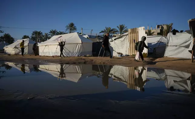 Sewage overflowed parts of a makeshift tent camp for displaced Palestinians in Deir al-Balah, Gaza Strip, Saturday, Jan. 17, 2026. (AP Photo/Abdel Kareem Hana)