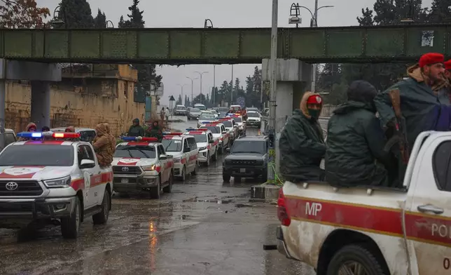 A Syrian military police convoy enters the Sheikh Maqsoud neighborhood, where clashes between government forces and Kurdish fighters have been taking place in the northern city of Aleppo, Syria, Sunday, Jan. 11, 2026. (AP Photo/Ghaith Alsayed)