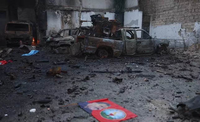 Burned vehicles at one of the Kurdish fighters positions at the Sheikh Maqsoud neighborhood, where clashes between government forces and Kurdish fighters have been taking place in the northern city of Aleppo, Syria, Sunday, Jan. 11, 2026. (AP Photo/Ghaith Alsayed)