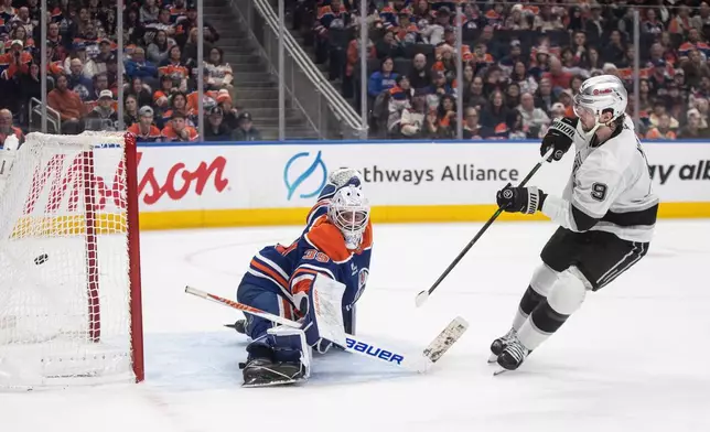 Los Angeles Kings' Adrian Kempe (9) scores on Edmonton Oilers goalie Connor Ingram (39) during a shootout of an NHL hockey game in Edmonton on Saturday, Jan. 10, 2026. (Jason Franson/The Canadian Press via AP)