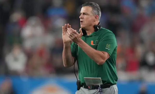 Miami head coach Mario Cristobal reacts after a touchdown during the first half of the Fiesta Bowl NCAA college football playoff semifinal game against Mississippi, Thursday, Jan. 8, 2026, in Glendale, Ariz. (AP Photo/Rick Scuteri)