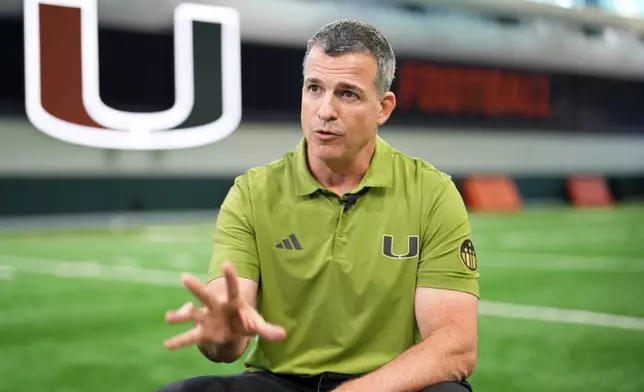 Miami football head coach Mario Cristobal speaks during an interview on the team's indoor practice field in Coral Gables, Fla., Monday, Jan. 12, 2026. (AP Photo/Rebecca Blackwell)