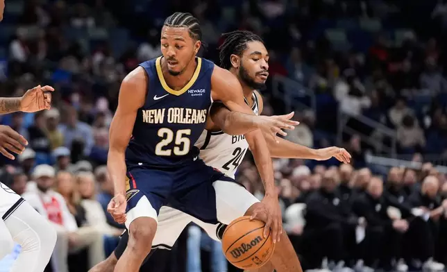New Orleans Pelicans forward Trey Murphy III (25) dribbles against Brooklyn Nets guard Cam Thomas (24) in the first half of an NBA basketball game, Wednesday, Jan. 14, 2026, in New Orleans. (AP Photo/Gerald Herbert)