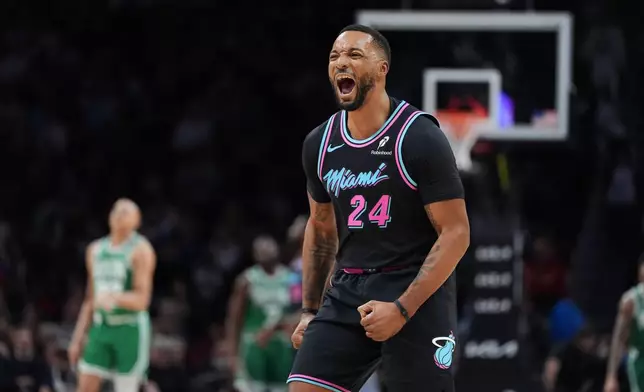 Miami Heat guard Norman Powell (24) reacts after making a shot during the first half of an NBA basketball game against the Boston Celtics, Thursday, Jan. 15, 2026, in Miami. (AP Photo/Rebecca Blackwell)