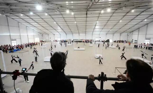 Volunteer dancers perform during rehearsals for the opening ceremony of the Milan Cortina 2026 Winter Olympic Games, at a compound in a big tent next to San Siro Stadium, in Milan, Italy, Saturday, Jan. 24, 2026. (AP Photo/Luca Bruno)