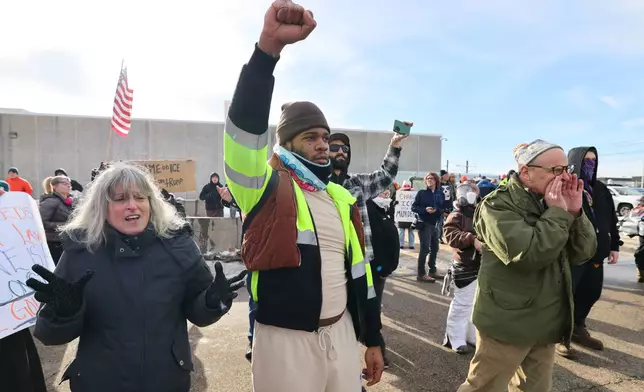 Protesters confront law enforcement outside the Bishop Henry Whipple Federal Building in Minneapolis, Friday, Jan. 9, 2026.(AP Photo/Adam Bettcher)
