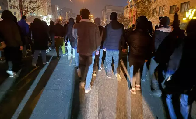 In this photo obtained by The Associated Press, Iranians attend an anti-government protest in Tehran, Iran, Thursday, Jan. 8, 2026. (UGC via AP)