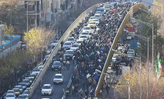 FILE - Protesters march on a bridge in Tehran, Iran, on Dec. 29, 2025. (Fars News Agency via AP, File)