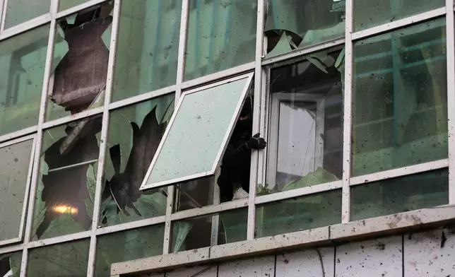 Damage to a building across the street is seen a day after an explosion at a Chinese restaurant killed at least seven people, including a Chinese national, in Kabul, Afghanistan, Tuesday, Jan. 20, 2026. (AP Photo/Siddiqullah Alizai)