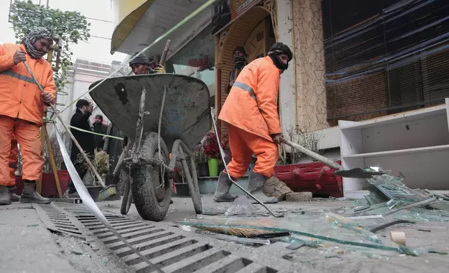Workers clean the scene after an explosion at a Chinese restaurant killed at least seven people, including a Chinese national, a day earlier in Kabul, Afghanistan, Tuesday, Jan. 20, 2026. (AP Photo/Siddiqullah Alizai)