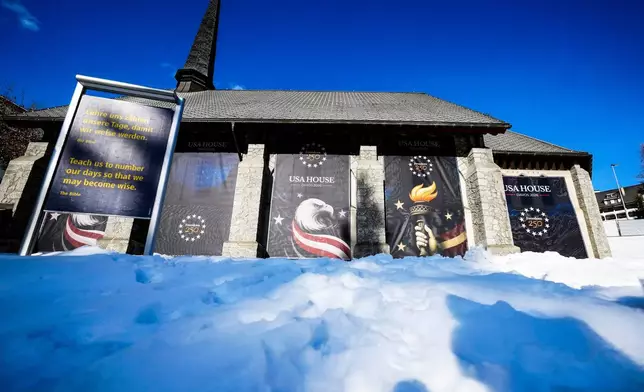 Posters cover the church hosting the United States House on the eve of the start of the Annual Meeting of the World Economy Forum in Davos, Switzerland, Sunday, Jan. 18, 2026. (AP Photo/Markus Schreiber)