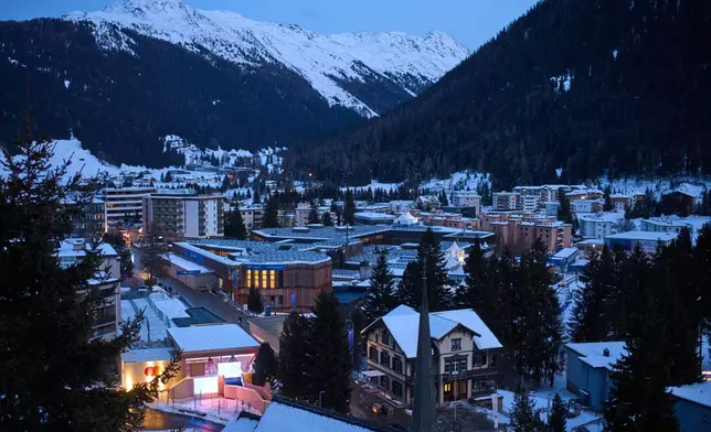 The windows of the Congress Center, center top, where the Annual Meeting of the World Economy Forum take place are illuminated in Davos, Switzerland, Saturday, Jan. 17, 2026. (AP Photo/Markus Schreiber)