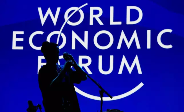 A man installs a microphone for the opening concert of the Annnual Meeting of the World Economy Forum at the Congress Center in Davos, Switzerland, Sunday, Jan. 18, 2026. (AP Photo/Markus Schreiber)