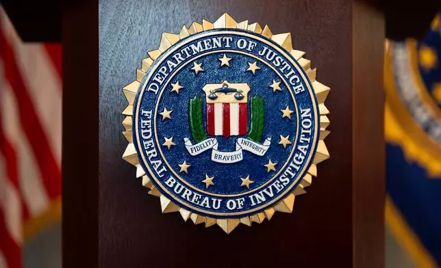 FILE - An FBI seal is displayed on a podium before a news conference at the field office in Portland, Ore., Jan. 16, 2025. (AP Photo/Jenny Kane, File)